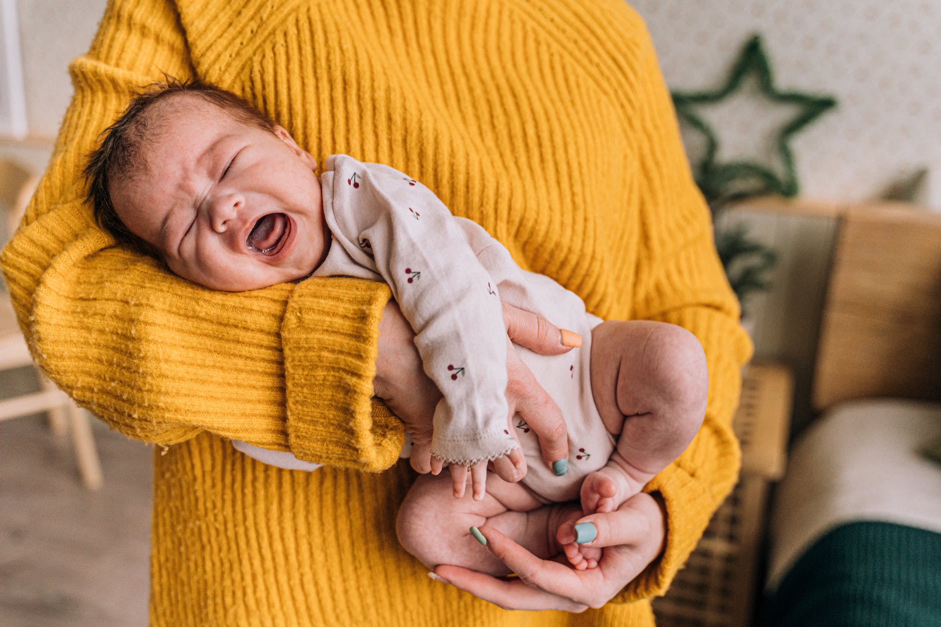 mother holding crying baby